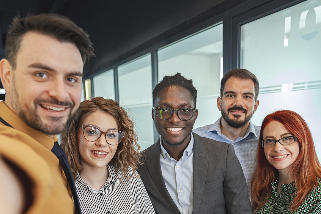 Equipe de trabalho reunida em uma selfie